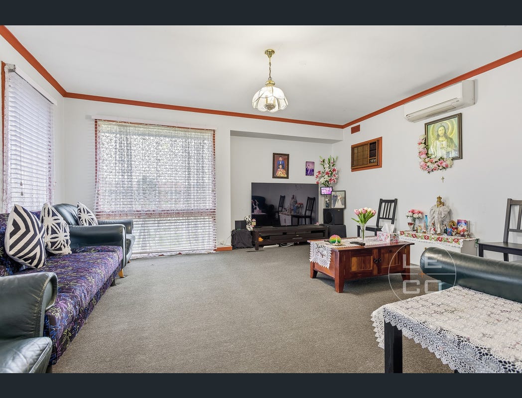 Lounge with a broad front window, carpet and seating