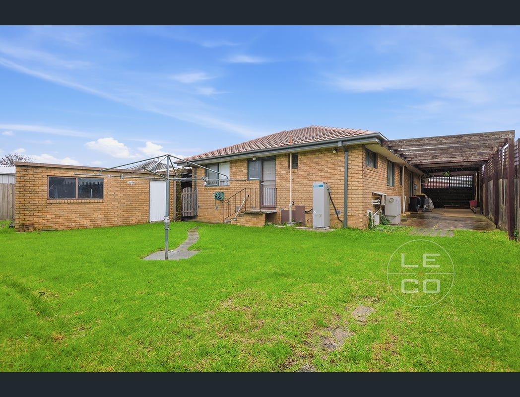 Rear lawn, back of the home, covered side area and detached garage