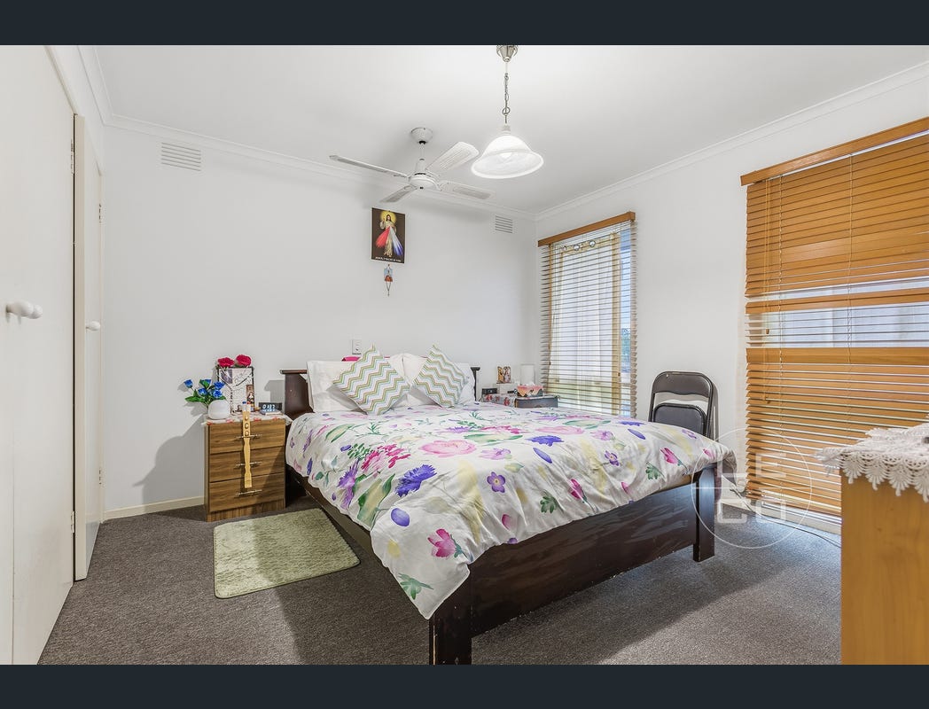 Bedroom with a double bed, two windows and built-in wardrobe doors